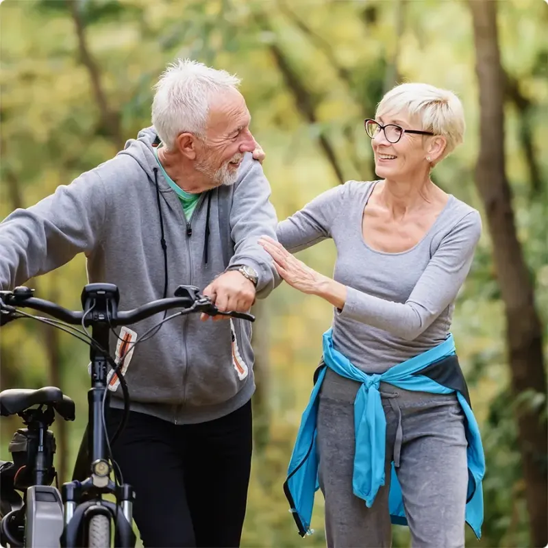 Couple walking bikes on a trail