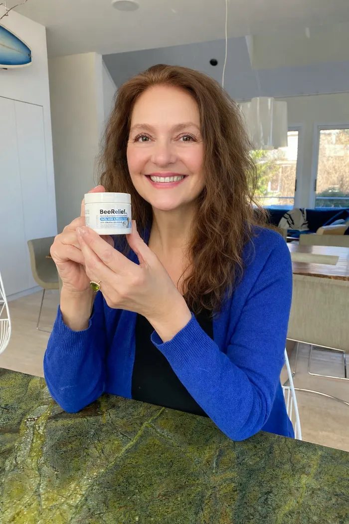 Aida Turturro holding a jar of BeeReliefXL